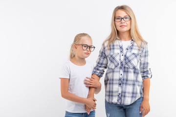 Portrait of mother and daughter with eyeglasses on white background