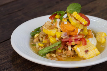 Spicy papaya salad with corn, salted eggs