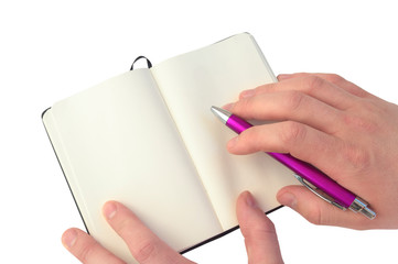 Hand is writing on a notebook with a pen composition. White background.