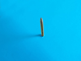 A bolt from the blue idiom something important or unusual that happens suddenly or unexpectedly closeup steel bolt  screw appearing from blue color background