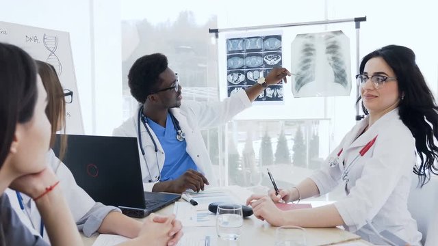 Group of multi-ethnic of professional doctors discussing x-ray prints of patient in the clinic. Health, hospital, profession people, technology and medicine concept
