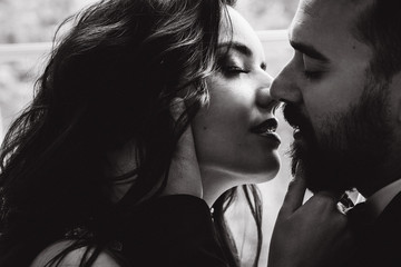 Portrait of the bride and groom. A passionate kiss.
