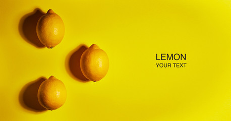 Creative layout made of lemon on yellow background. Flat lay, top view, copy space . Food concept.