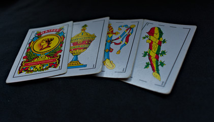 Spanish playing card, aces of golds, cups, swords and maces one behind another