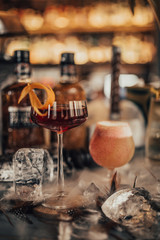 A close up shot of whisky cocktails with ice cubes and dry ice. Concept of fine alcohol, beverage and mixed cocktails. Luxurious lifestyle. Selective focus on the cocktails.