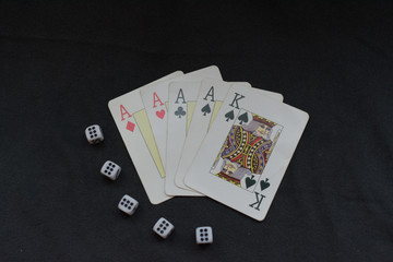 conceptual image about gambling games: dice and cards showing a lucky hand and many sixes on the dice