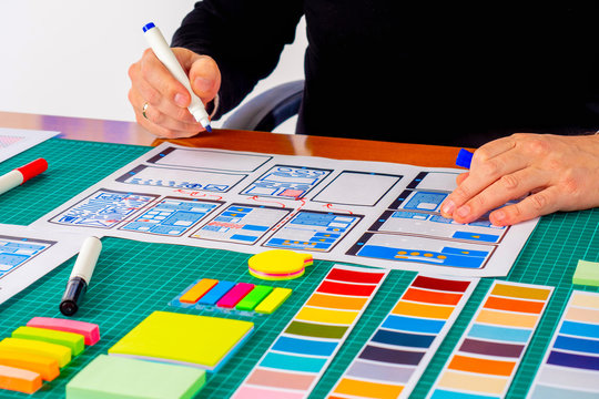 ux The graphic designer is working on a model of the future mobile application. Designer sketches the future concept of a web application.