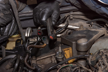Fototapeta na wymiar Repairing Of Diesel Engine Close Up Of Worker Hands. Repairing of modern diesel engine. Close-up of an auto mechanic working on a car motor.