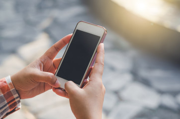 hipster woman using mobile phone touching screen at outdoor with hands typing smart phone texting messaging lifestyle working app device technology internet social data online concept vintage style.