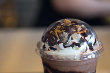 Chocolate sauce whipped cream nut and brownies on top iced drink