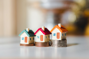 Miniature colorful house on stack coins using as property and financial concept