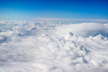 Fototapeta na wymiar beautiful blanket of clouds from above with blue sky