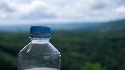 clear water in the bottle in the natural background