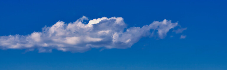 Blue sky background with a long white cloud. panorama