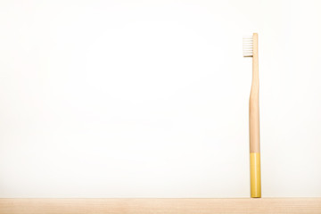 yellow colours bamboo toothbrushes on white background. Place for text. Ecoproduct.   eco-friendly.