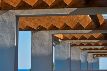 Contemporary corridor of tropical resort terrace under wooden beams