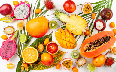 Still life with fresh assorted exotic fruits on a palm leaf.