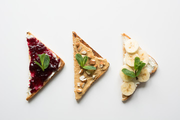 Different types of sandwiches for healthy and sugar-free children's breakfast, nut paste, bananas, berry jam.