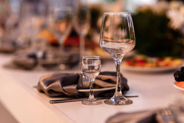 Table set for an event party or wedding reception. Wedding table setting. wine glasses