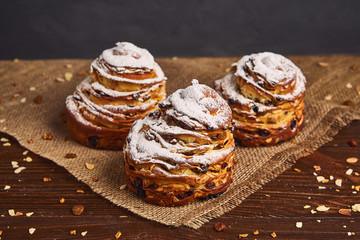 Tasty sweet buns with raisins and icing sugar. Homemade baking concept
