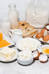 assortment of fresh dairy products on white background, vertical closeup