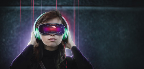 Young woman in glasses virtual reality headset goggles and headphones portrait. VR headset and technology augmented reality concept.