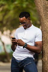 Outdoor portrait of a Young black African American young men talking  on mobile phone
