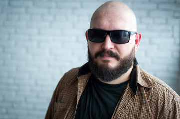 Fototapeta premium Portrait of a bald man in a shirt with a beard