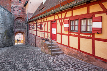 Traditional sidewalk restaurant tables with tablecloths in Nuremberg Old Town