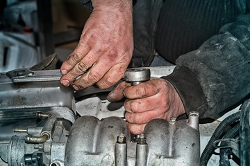 car repair concept, auto mechanic hands servicing engine mechanisms, close-up,