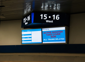 Train station message sign indicating that trains are delayed due to an active shooter