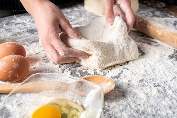 Making dough by female hands at bakery