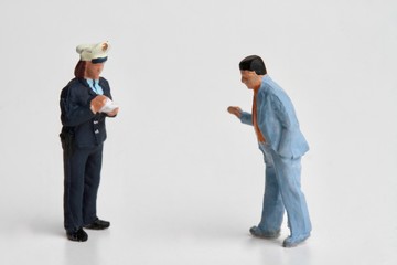 miniature of  a policewoman writing a ticket for a violation