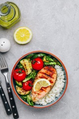 Grilled salmon steak with and rice, zucchini, broccoli, tomato .