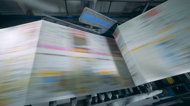 Printing conveyor moving newspaper in a typography facility.