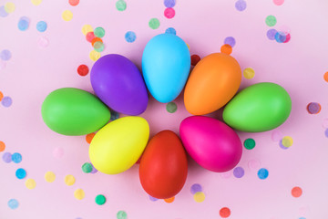 Colored Easter eggs on pink background. Flatlay.