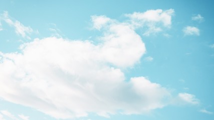 Fluffy white cloud on the blue aquamarine color sky background. 16:9
