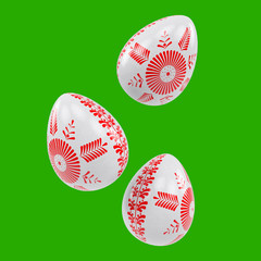 Three 3D Easter white eggs with red ornaments on green solid background. Ukrainian pysanka