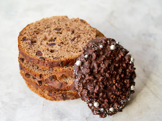 Amazing Chocolate Easter Cake with chocolate drops and dry cherries on gray wooden background. Round slices of cake. Easter concept. Selective focus, close up