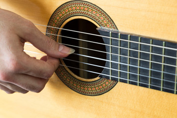 Obraz premium close up photo that the man play guitar with long nail finger.