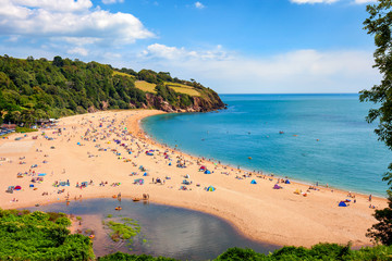 A sunny seascape with people enjoying the beach at Blackpool sands near Dartmouth in Devon  - obrazy, fototapety, plakaty