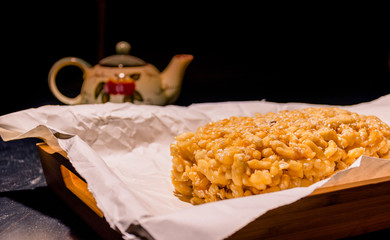 Sweet asian cake chak-chak with honey on wooden board