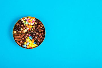Colorful lollipops and different colored round candy. Top view.