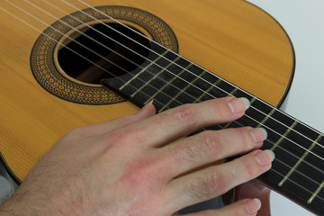 Obraz premium close up photo that the man play guitar with long nail finger.