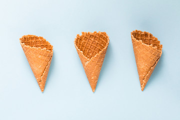 Three Waffle cornet on light blue background.