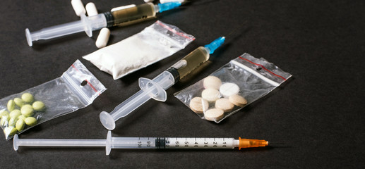 Hard drugs on dark table. heroin, cocaine, amphetamine, ecstasy, pills and more. Creative idea....