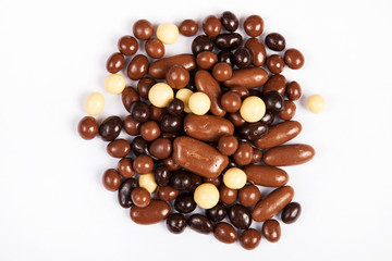 Milk chocolate pieces isolated on white background from top view