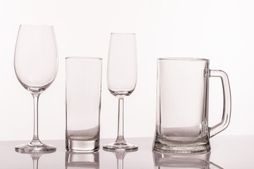 A variety of empty glasses for alcoholic beverages isolated on white background. Close up