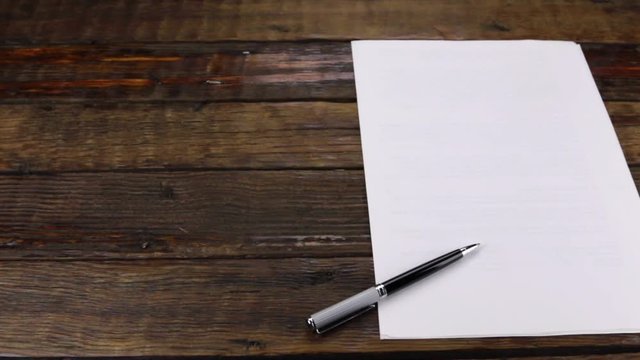 Slider shot, pen lying on a clean sheet of paper, with copy space.