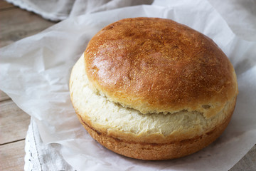 Fresh homemade wheat yeast bread on a linen tablecloth. Rustic style.